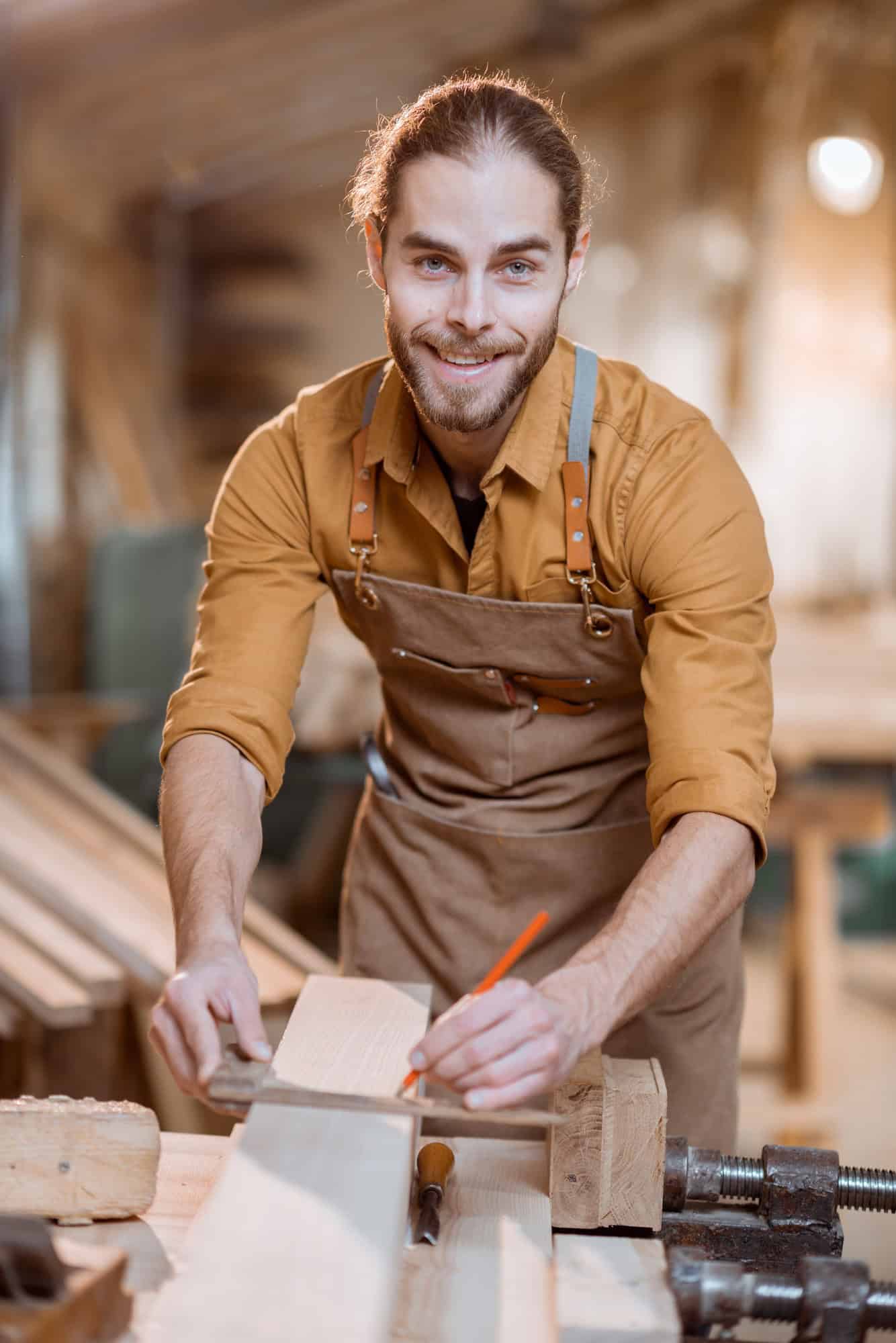 Carpenter working with a wood in the workshop